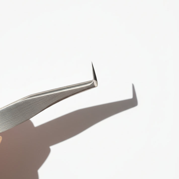Metal tweezers on a white background