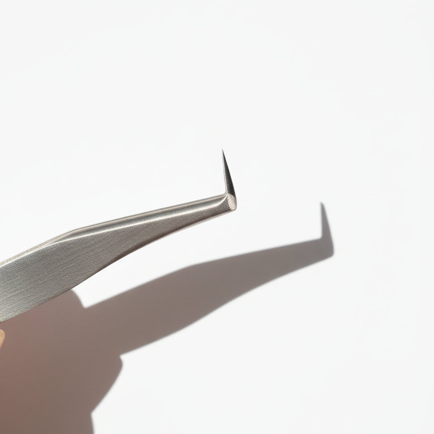 Metal tweezers on a white background